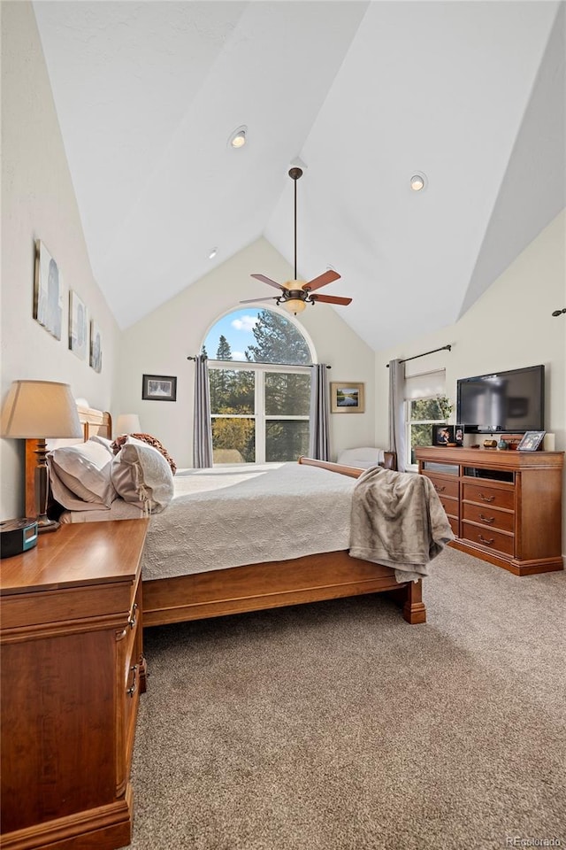 bedroom with ceiling fan, carpet flooring, and vaulted ceiling