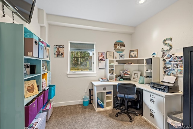 office space with built in desk and carpet flooring