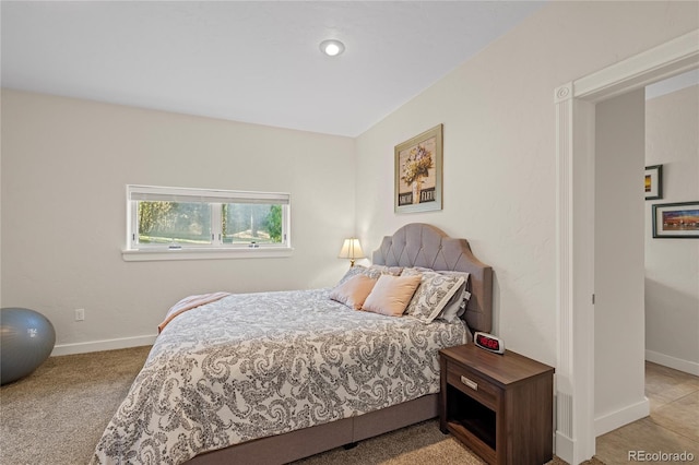 bedroom featuring light carpet