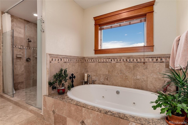 bathroom featuring separate shower and tub