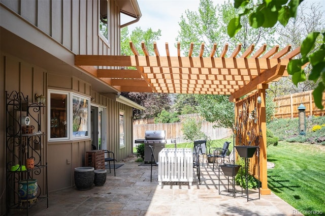 view of patio featuring a grill, fence, and a pergola