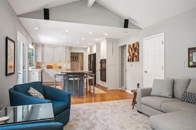 living area featuring recessed lighting, light wood-style floors, light carpet, and baseboards