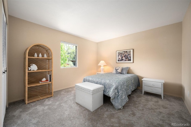 carpeted bedroom featuring baseboards