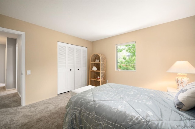 carpeted bedroom featuring a closet and baseboards