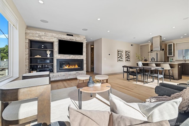 3615 Navajo St, Denver, CO 80211 - living room featuring light wood-type flooring, a large fireplace, recessed lighting, and baseboards