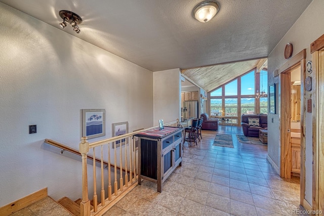 2680 Wild Bill Blvd, Westcliffe, CO 81252 - corridor featuring vaulted ceiling, a textured ceiling, and a textured wall