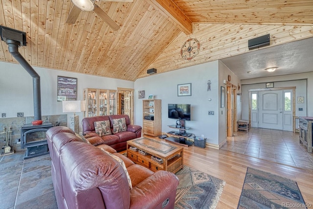 2680 Wild Bill Blvd, Westcliffe, CO 81252 - living room with a wood stove, a wood ceiling with exposed beams, a ceiling fan, high vaulted ceiling, and wood finished floors