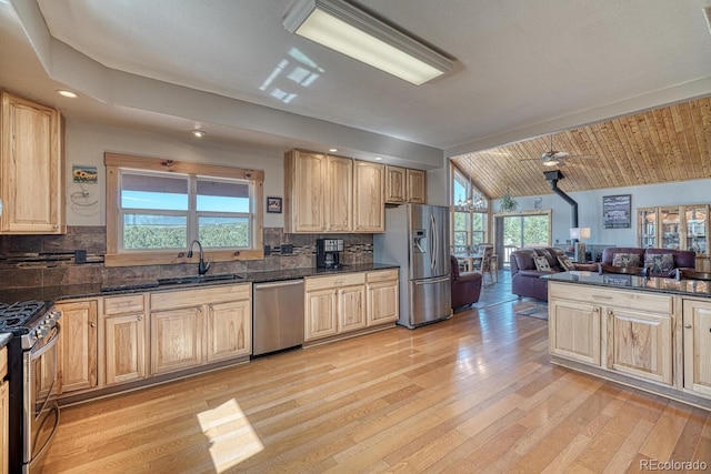2680 Wild Bill Blvd, Westcliffe, CO 81252 - kitchen with appliances with stainless steel finishes, light brown cabinetry, light wood-style flooring, open floor plan, and vaulted ceiling