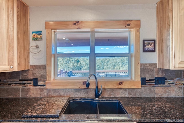 2680 Wild Bill Blvd, Westcliffe, CO 81252 - kitchen featuring decorative backsplash, healthy amount of natural light, and dark stone countertops
