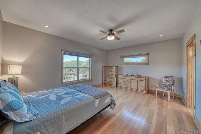 2680 Wild Bill Blvd, Westcliffe, CO 81252 - bedroom with multiple windows, light wood-style flooring, a textured ceiling, recessed lighting, and a ceiling fan