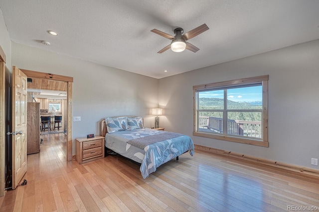 2680 Wild Bill Blvd, Westcliffe, CO 81252 - bedroom with light wood-style flooring, a textured ceiling, and a ceiling fan