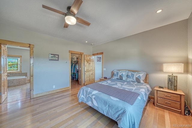 2680 Wild Bill Blvd, Westcliffe, CO 81252 - bedroom with wood finished floors, a spacious closet, a closet, connected bathroom, and recessed lighting