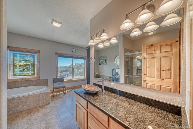 2680 Wild Bill Blvd, Westcliffe, CO 81252 - full bath featuring a stall shower, vanity, a garden tub, tile patterned flooring, and a textured ceiling