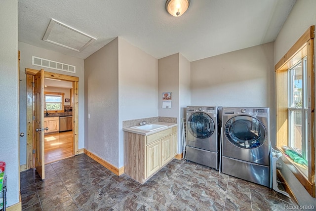 2680 Wild Bill Blvd, Westcliffe, CO 81252 - laundry room with independent washer and dryer, attic access, stone finish floors, and cabinet space