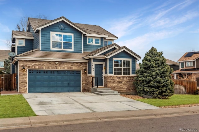 craftsman-style house featuring driveway, a tiled roof, fence, and brick siding