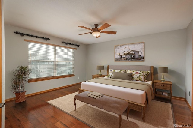 bedroom featuring wood finished floors, a ceiling fan, and baseboards