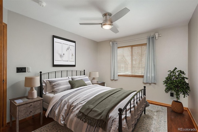 bedroom featuring ceiling fan, wood finished floors, and baseboards