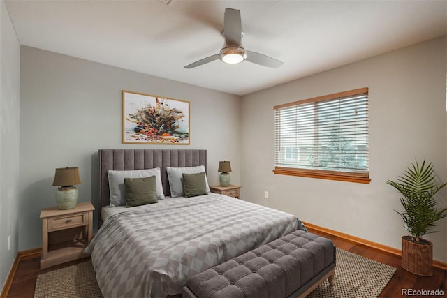 bedroom featuring a ceiling fan, baseboards, and wood finished floors