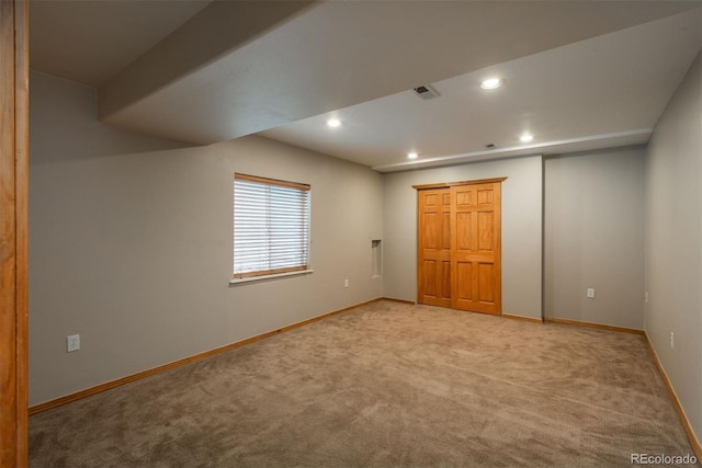 unfurnished room featuring recessed lighting, light colored carpet, and baseboards