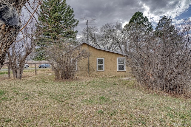 view of side of property featuring a yard