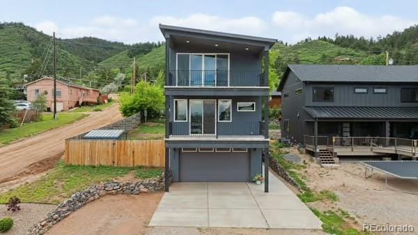 260 Upper Glenway Rd, Palmer Lake, CO 80133 - back of property with concrete driveway, a garage, and a balcony