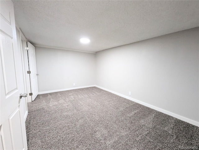 unfurnished bedroom featuring carpet flooring, baseboards, and a textured ceiling