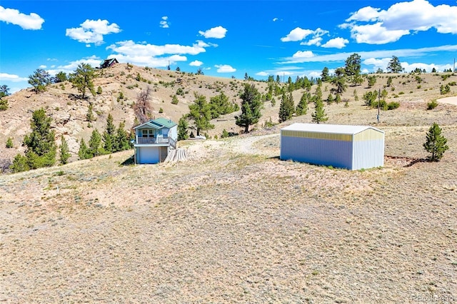 165 Coyotero Trl, Hartsel, CO 80449 - view of yard featuring an outdoor structure, view of desert, and a view of rural / pastoral area