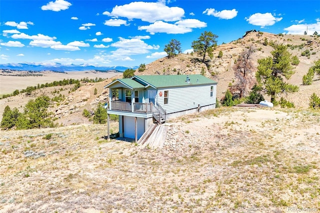 165 Coyotero Trl, Hartsel, CO 80449 - back of house featuring a garage, a mountain view, and view of desert