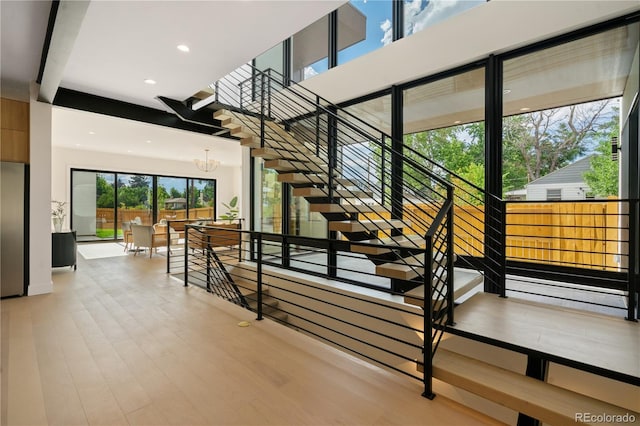 1601 S Columbine St, Denver, CO 80210 - staircase with a chandelier, wood finished floors, and recessed lighting