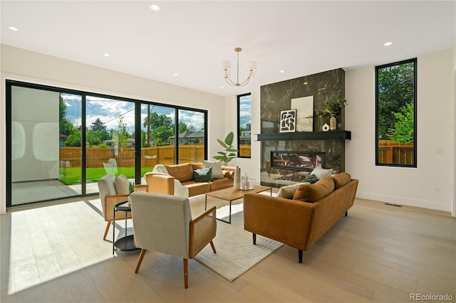 1601 S Columbine St, Denver, CO 80210 - living room featuring light wood-type flooring, a chandelier, recessed lighting, a premium fireplace, and baseboards