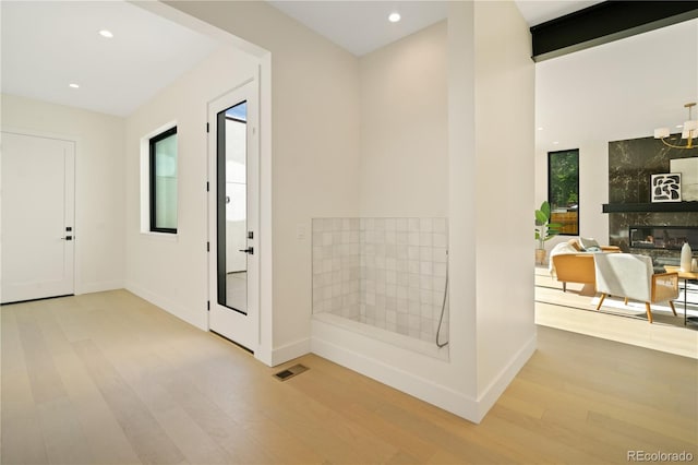 1601 S Columbine St, Denver, CO 80210 - hallway with light wood-style flooring, baseboards, recessed lighting, and a chandelier