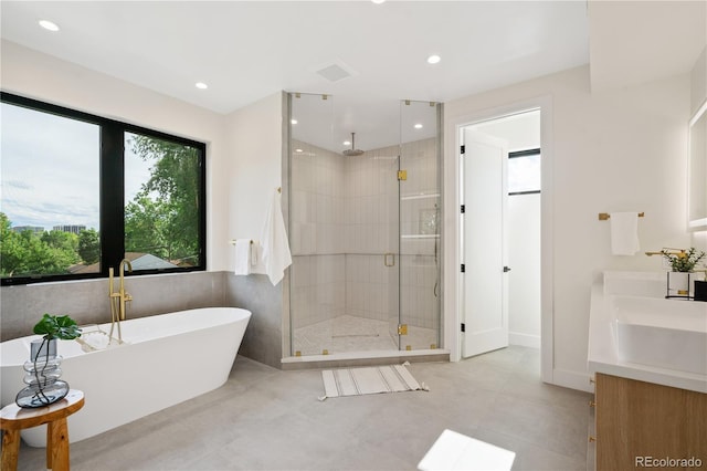 1601 S Columbine St, Denver, CO 80210 - bathroom with a stall shower, a soaking tub, double vanity, recessed lighting, and tile patterned flooring