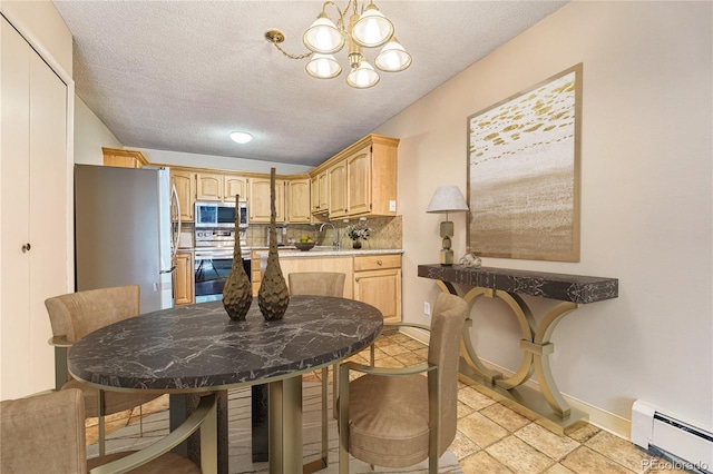 dining space with sink, vaulted ceiling, a notable chandelier, a textured ceiling, and a baseboard radiator