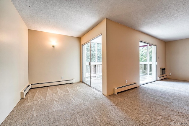 carpeted empty room with a baseboard radiator and a textured ceiling