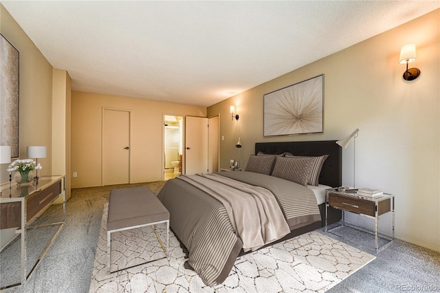 carpeted bedroom with connected bathroom