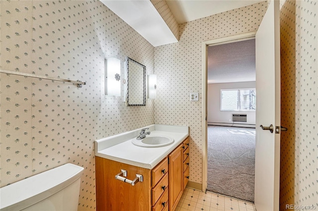 bathroom featuring vanity, baseboard heating, and toilet