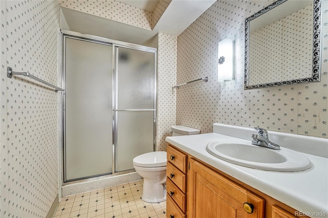 bathroom with an enclosed shower, vanity, and toilet