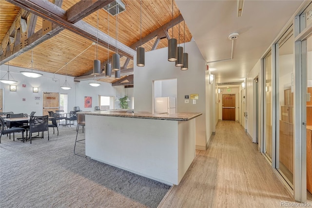 kitchen with hanging light fixtures, white fridge, high vaulted ceiling, and wood ceiling