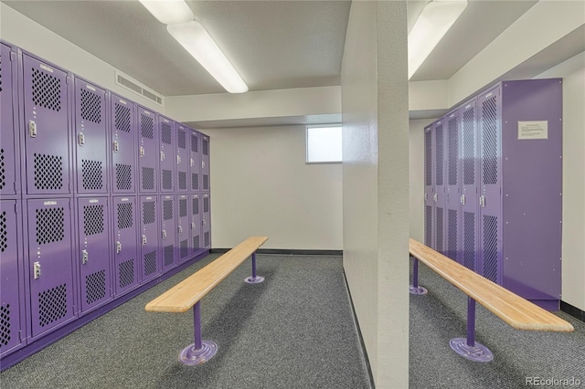 interior space featuring carpet flooring and a textured ceiling