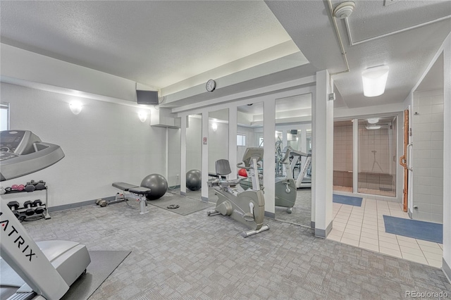 workout room featuring a textured ceiling