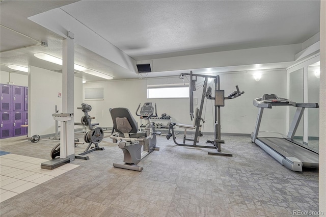 gym with carpet flooring and a textured ceiling