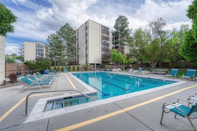 view of pool with a jacuzzi and a patio