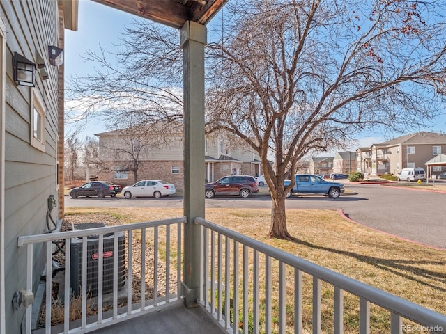 balcony with a porch, a residential view, and central AC