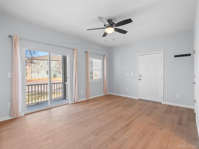 empty room featuring a ceiling fan, light wood-style floors, and baseboards