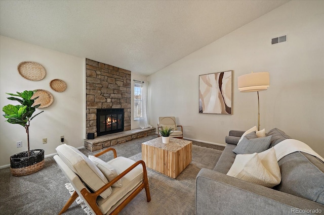 living room with visible vents, a textured ceiling, a fireplace, carpet flooring, and vaulted ceiling