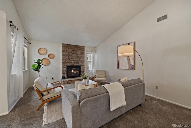 living area featuring visible vents, lofted ceiling, carpet flooring, a fireplace, and a textured ceiling