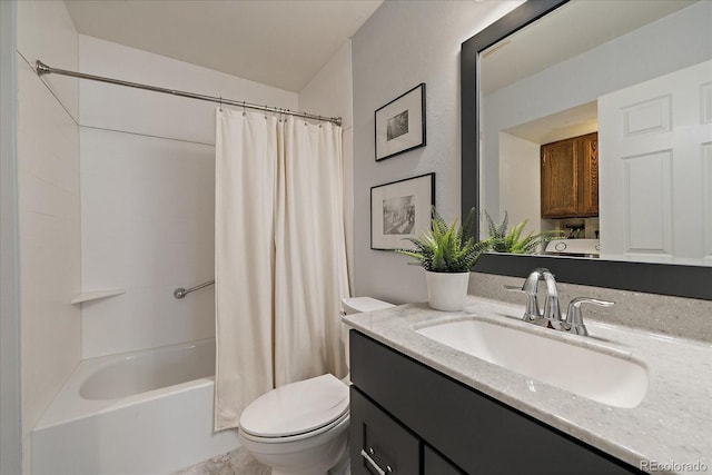 bathroom with vanity, shower / tub combo, and toilet