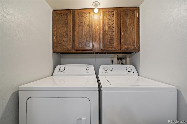 laundry area with washing machine and dryer and cabinet space