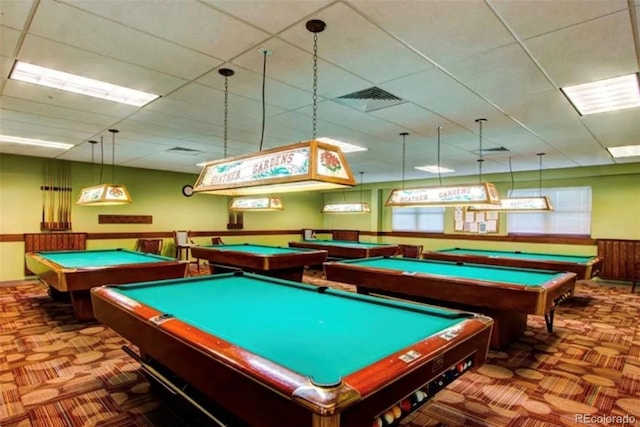 rec room featuring visible vents, a paneled ceiling, carpet, and a wainscoted wall