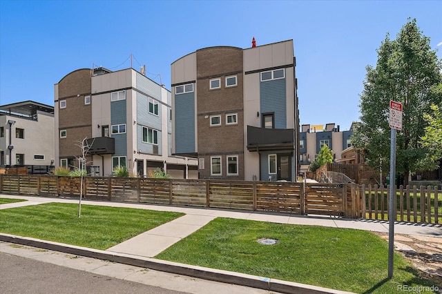 1632 Lowell Blvd Unit 5, Denver, CO 80204 - view of building exterior with a fenced front yard